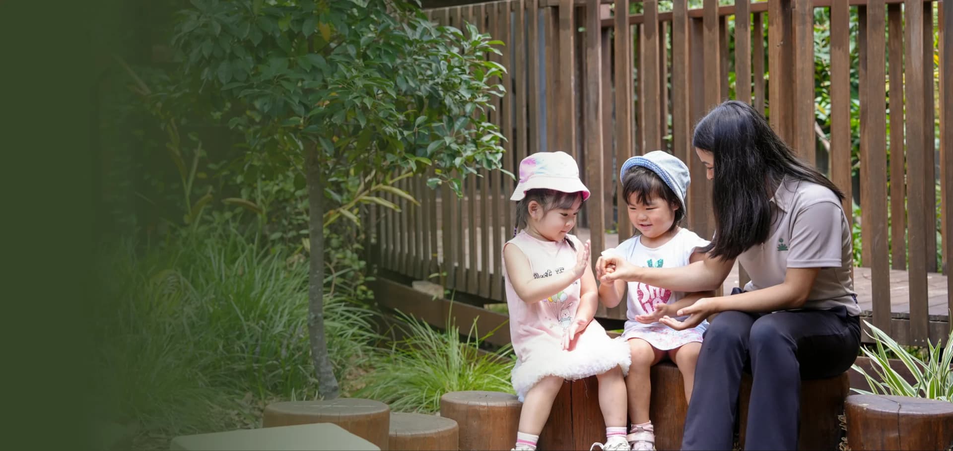 Educator and children in the garden play area at a Simba Education early learning centre in Sydney