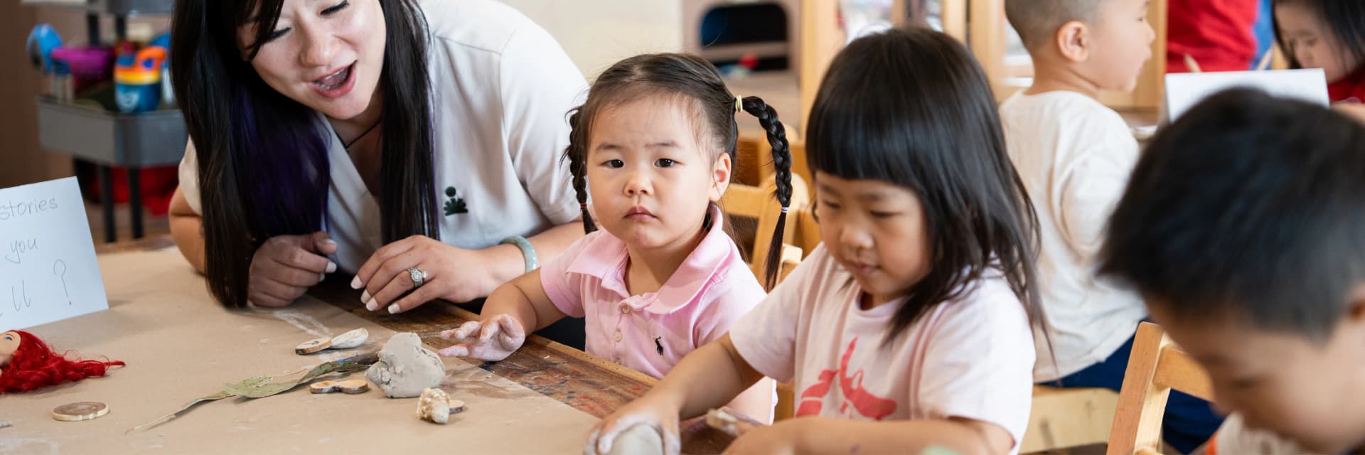 Educator and children exploring clay together at a Simba Education Sydney early learning centre